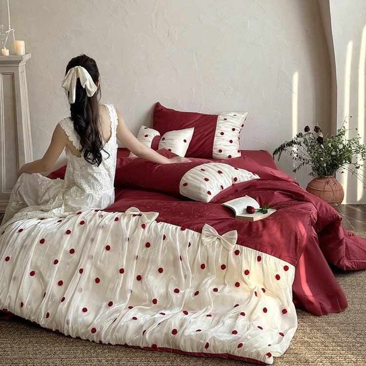 Romantic bed linen set with tulle overlay, pom pom appliqués, and decorative bows