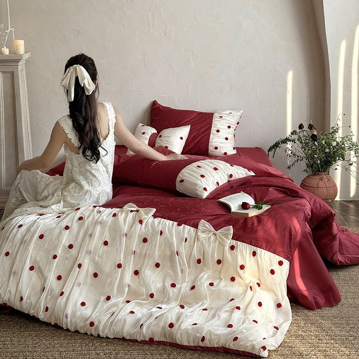 Romantic bed linen set with tulle overlay, pom pom appliqués, and decorative bows