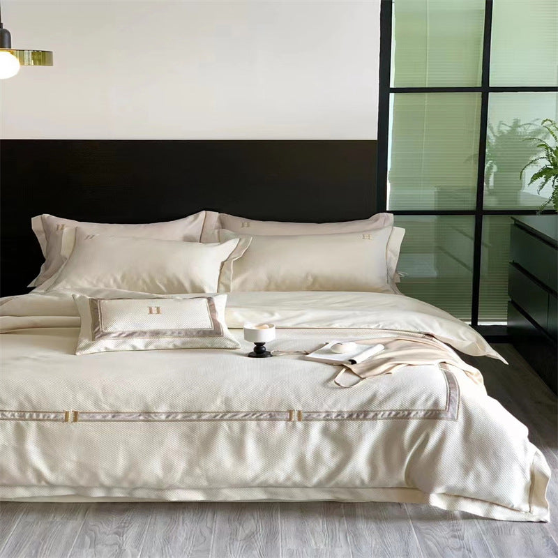 Exclusive satin bedding set with fine piping and monogram embroidery
