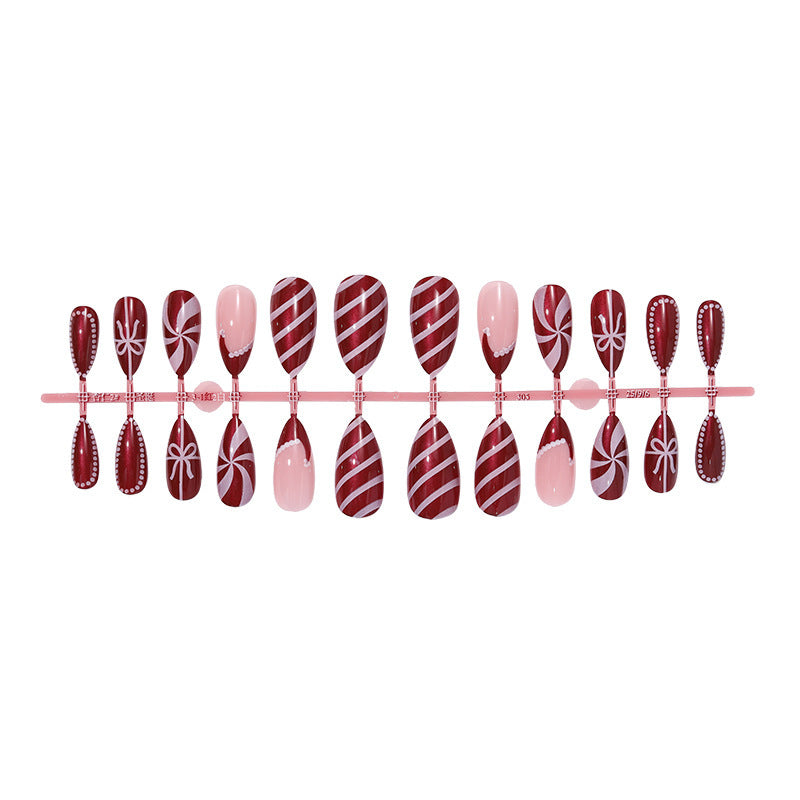 artfully designed nail set with festive candy cane motifs Kalsten