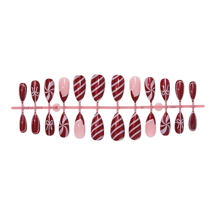 artfully designed nail set with festive candy cane motifs Kalsten