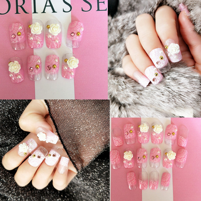 Artificials nails with sparkling rhinestone accents and elegant flower embellishments Kalsten