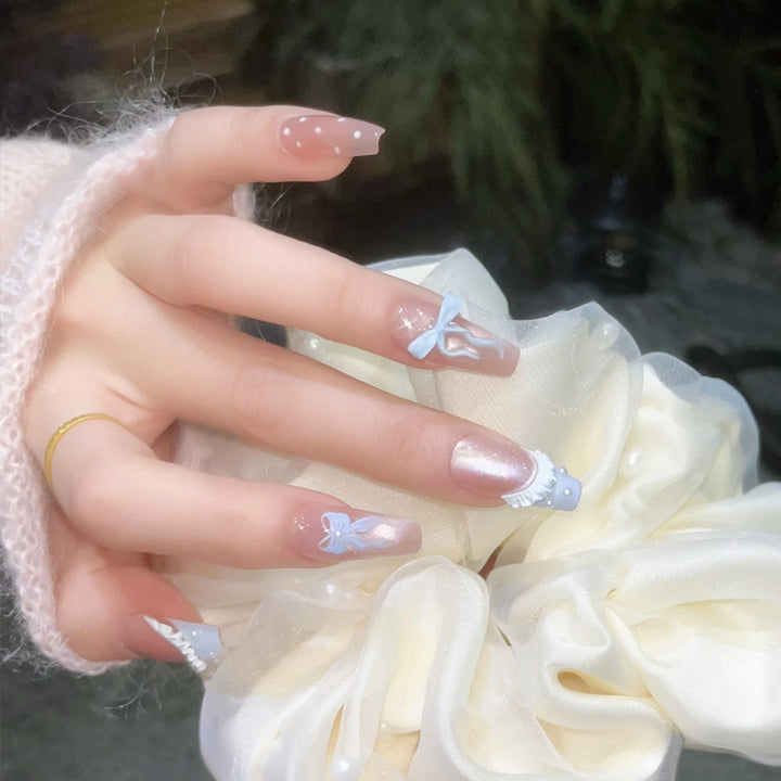 Art nail set with filigree bows and glitter accents Kalsten