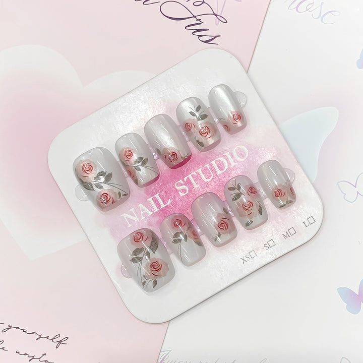 Artful nail extensions with rose designs Kalsten