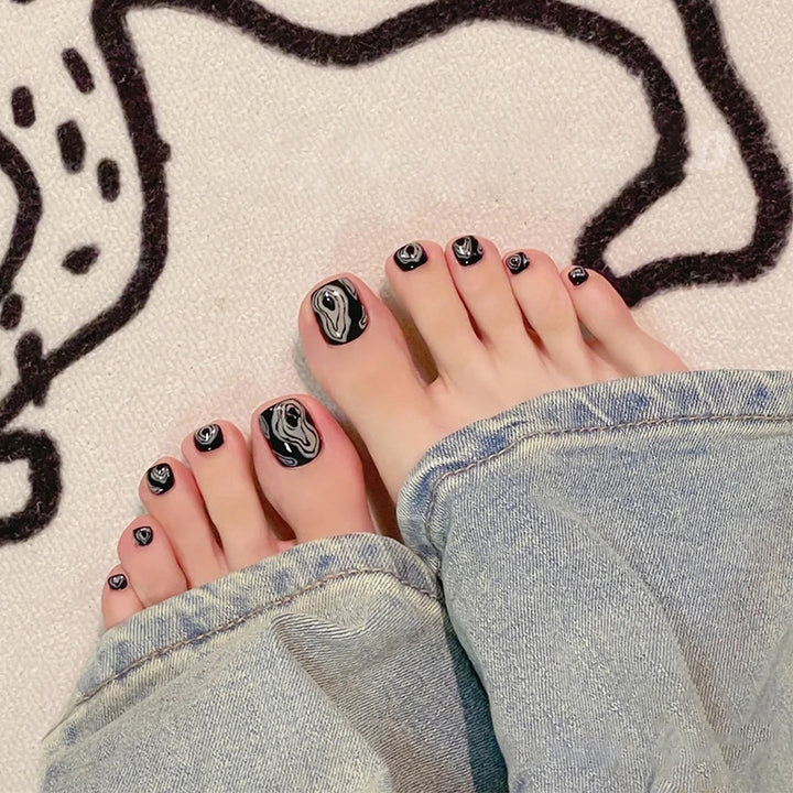 Artistic toenail art with rhinestone and glitter elements Kalsten