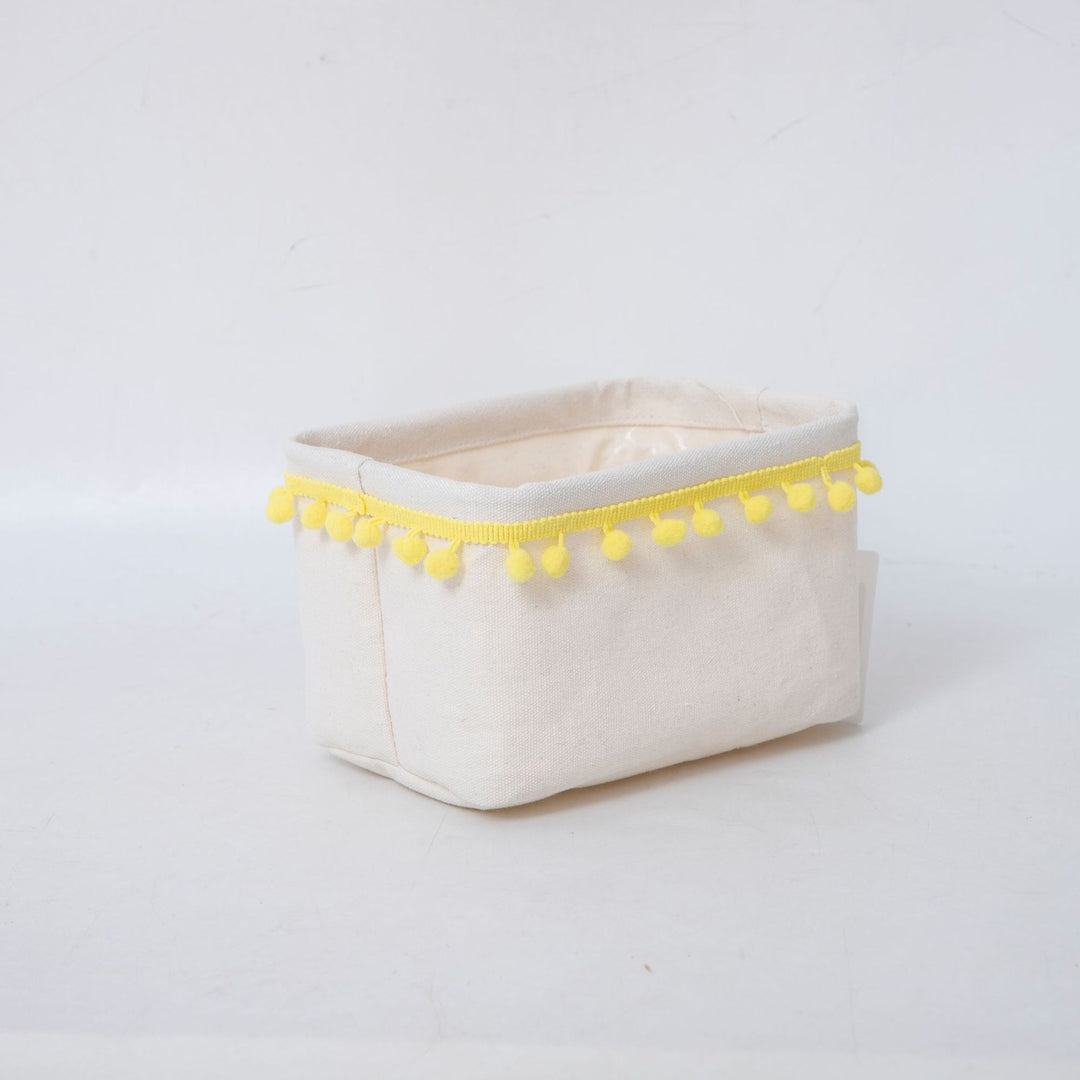 Storage basket with decorative pom-pom trim