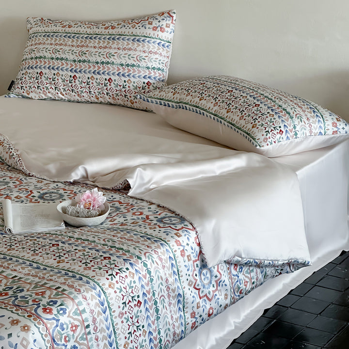 Satin bed linen set with ruffled bed skirt and floral printed pillowcases