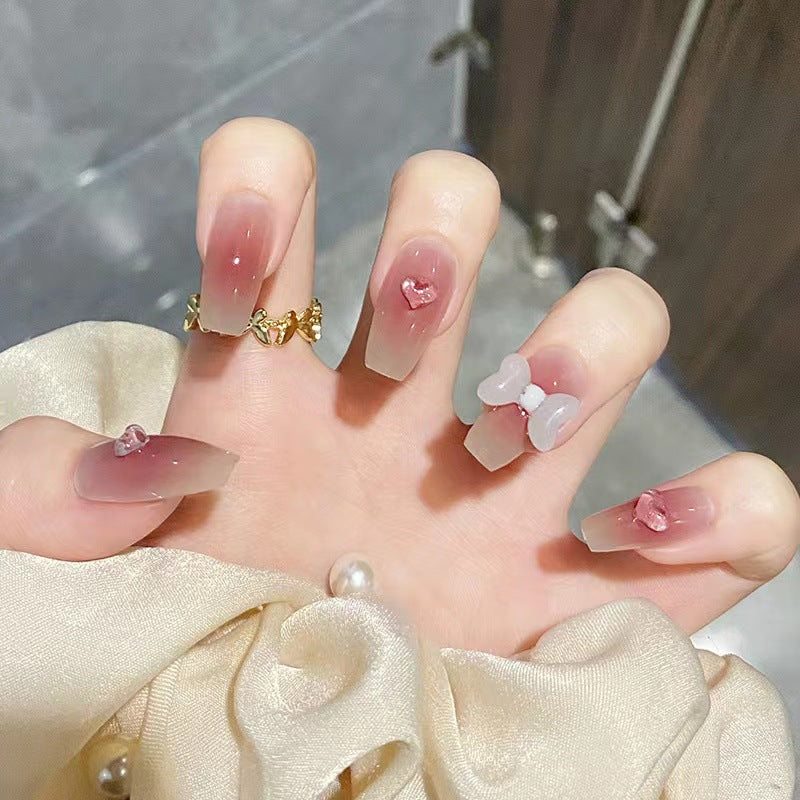 Artful acrylic nails with heart and bow design Kalsten