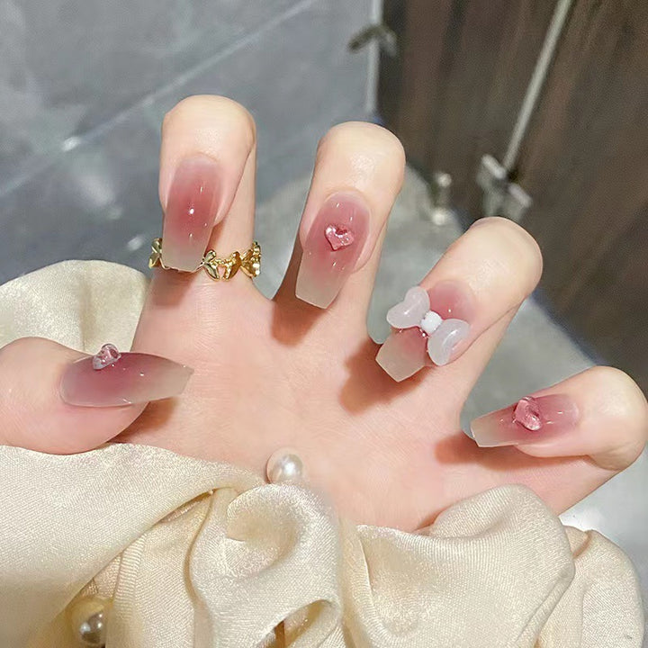 Artful acrylic nails with heart and bow design Kalsten