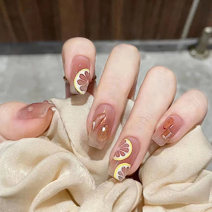 Artificial nail set with cheerful citrus motifs and elegant designs Kalsten