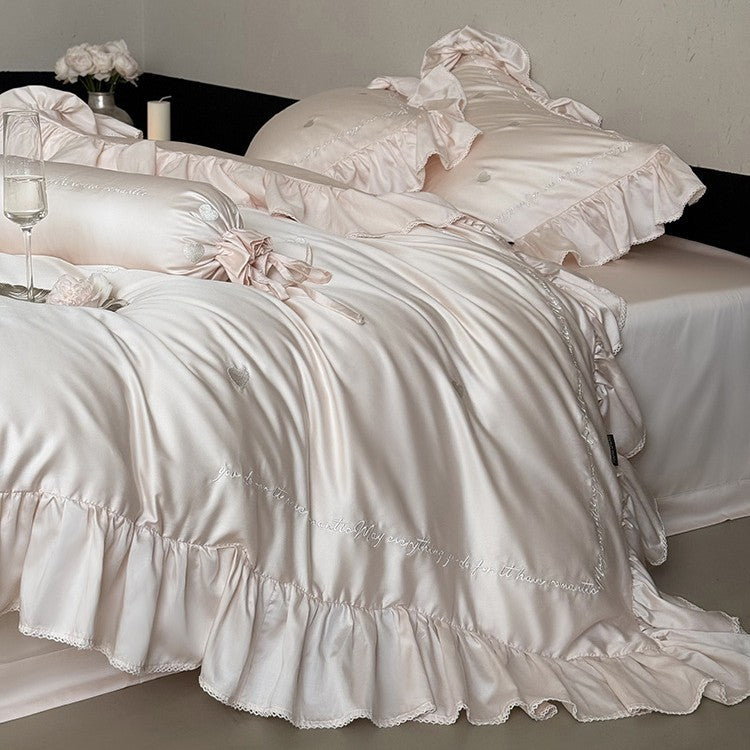 Luxurious cotton satin bedding set with ruffled trim, embroidered heart motifs, and calligraphic writing