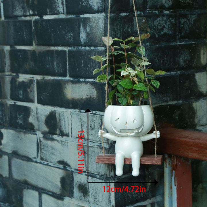 Hanging ceramic pumpkin flower pot with carved pumpkin face and jute string
