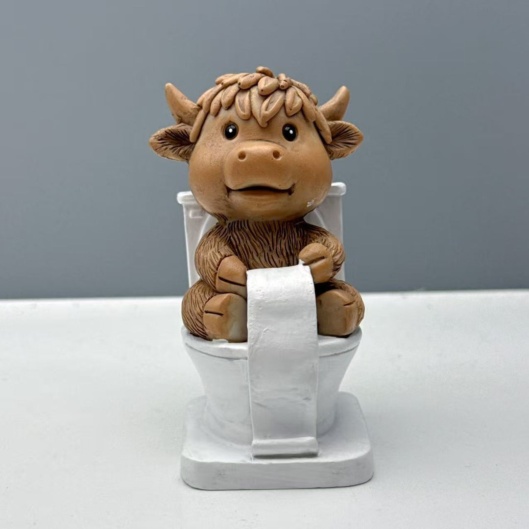 Funny decorative figure of a Highland cow on toilet Kalsten