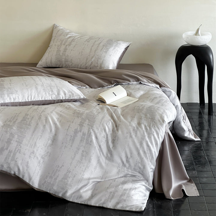 Luxurious satin bedding set with floral watercolor print, ruffled edges and reversible function