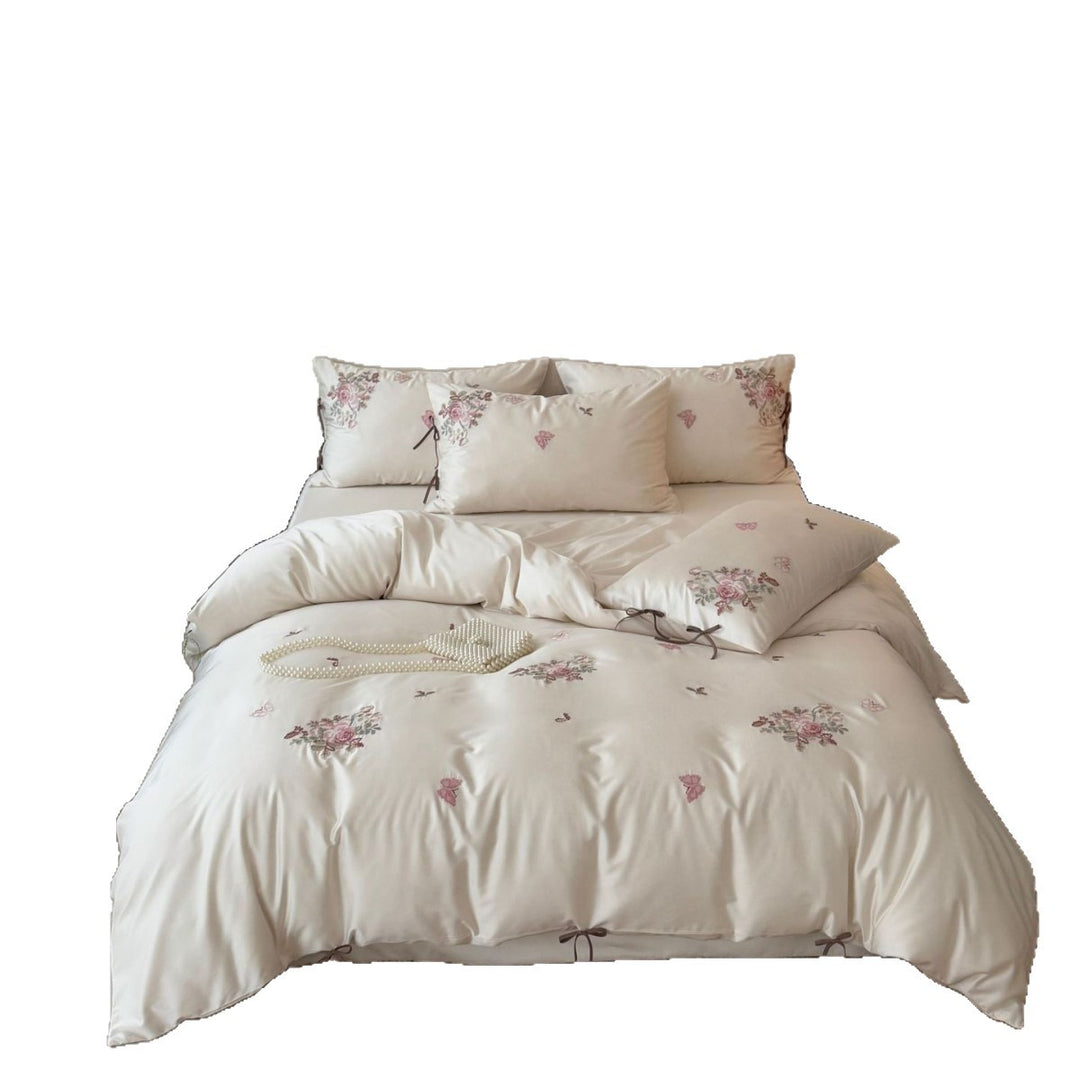 Fine satin bedding set with floral embroidery, tie ribbons and fine quilted texture Kalsten
