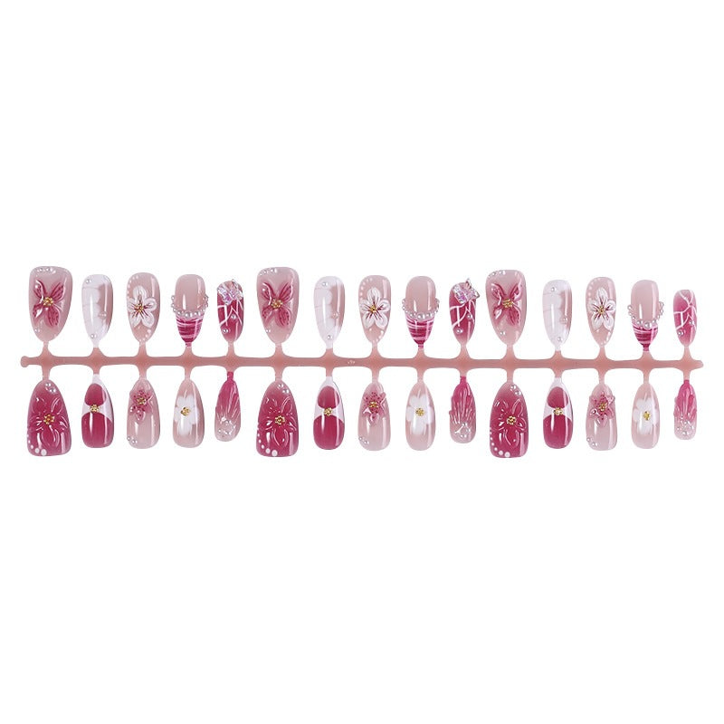 Creative acrylic nail set with floral accents and glitter decorations Kalsten