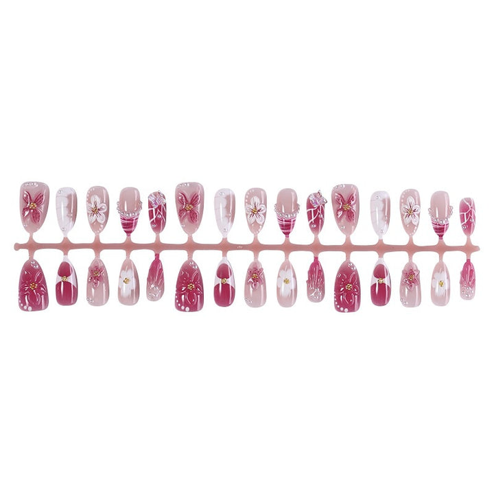 Creative acrylic nail set with floral accents and glitter decorations Kalsten