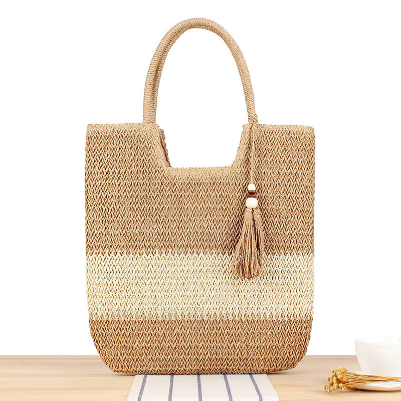 Fashionable beach tote bag made of woven natural material with fringed detail Kalsten