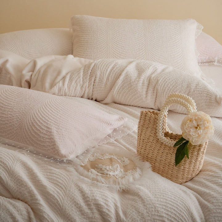 Quilted bedding set with lace edge and wave quilting pattern
