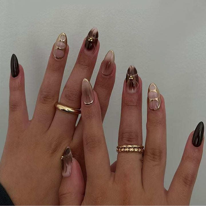 Artificial nail set with elegant ombre design and gold embellishments Kalsten