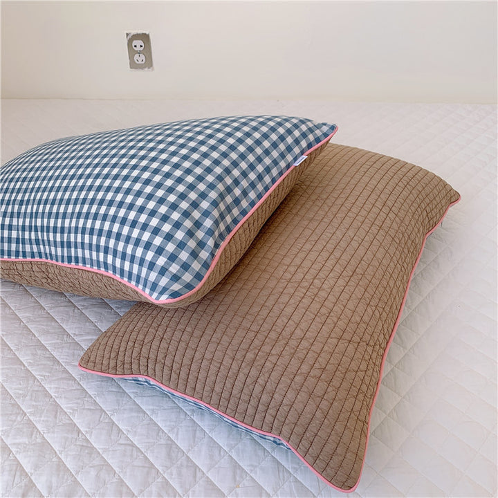 Reversible quilted pillow set with checked cotton cover and contrasting piping