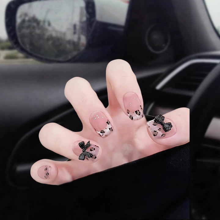 Artistic Press-On Nail Set with Playful Bow and Animal Print Designs