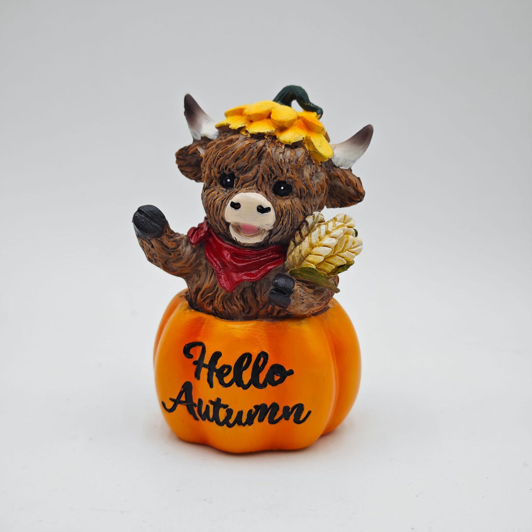Funny decorative figure of a Highland cow in pumpkin costume Kalsten