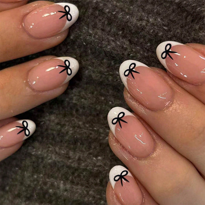 Acrylic nail set with playful bow design Kalsten