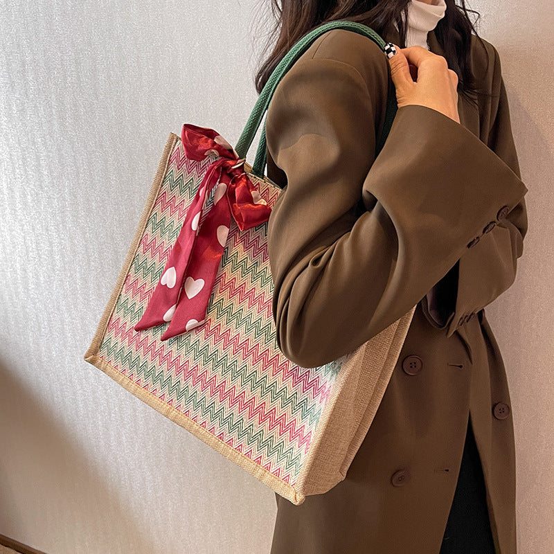 Textured Handbag with Decorative Bow