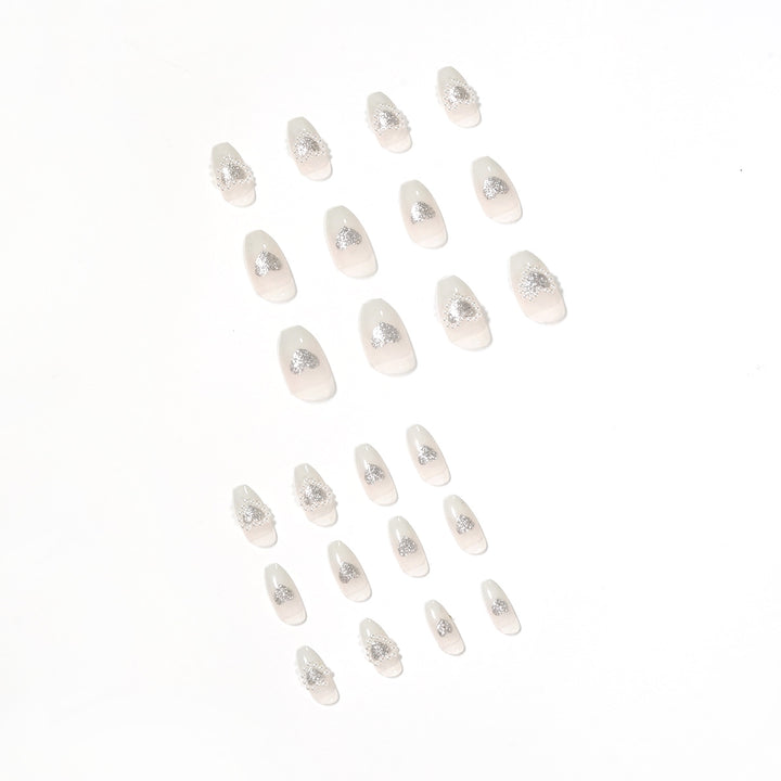 Artificial nail art with heart and rhinestone decorations Kalsten