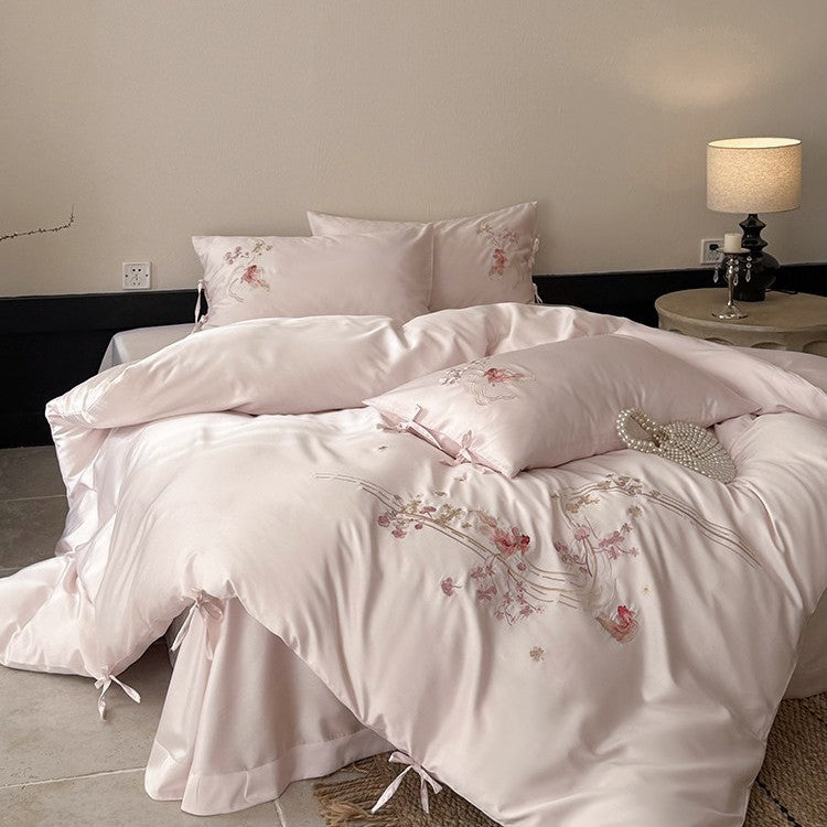 Satin bedding set with floral embroidery, ribbon ties and silky surface