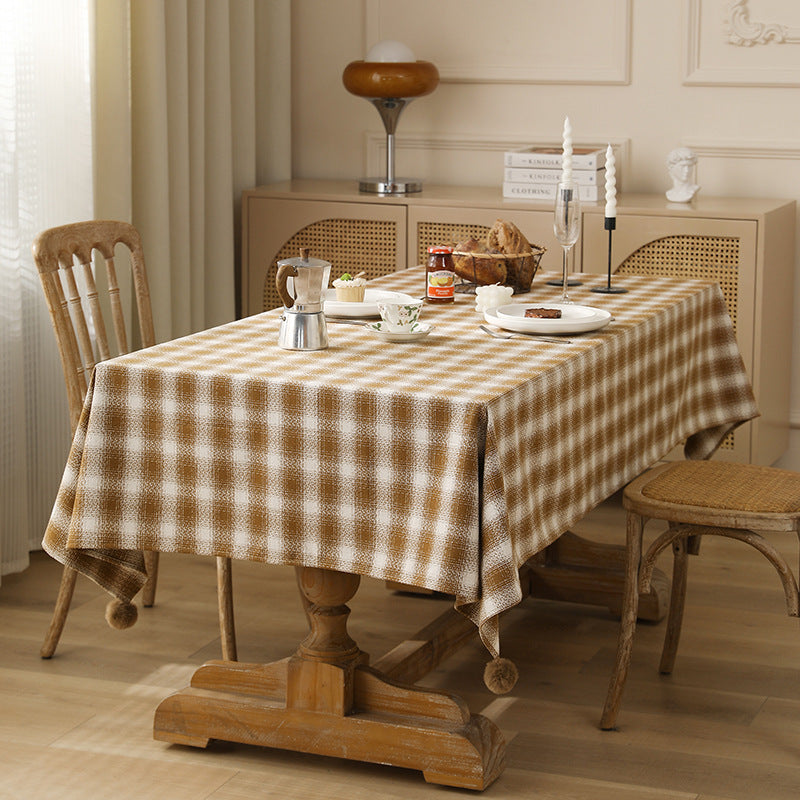 Square tablecloth made of cotton blend fabric with checkered weave pattern and pom-pom corners Kalsten