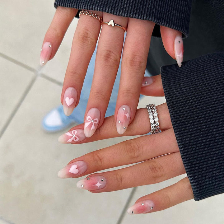 Acrylic nail set with romantic heart and bow design Kalsten