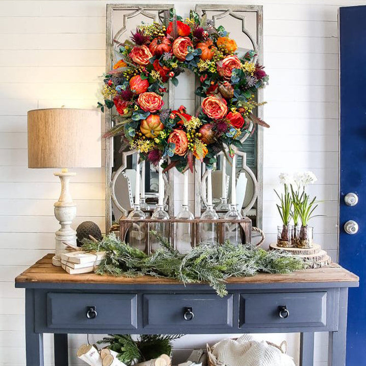 Autumn wreath with artistic roses, mini pumpkins, and eucalyptus branches