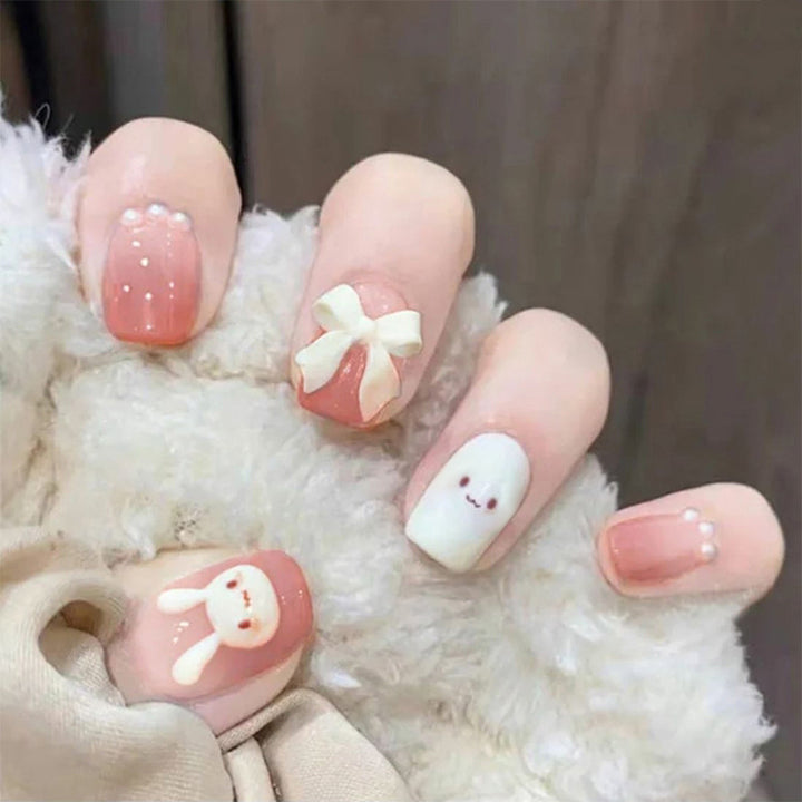 Glamorous artificial nails with heart design and glittering accents Kalsten