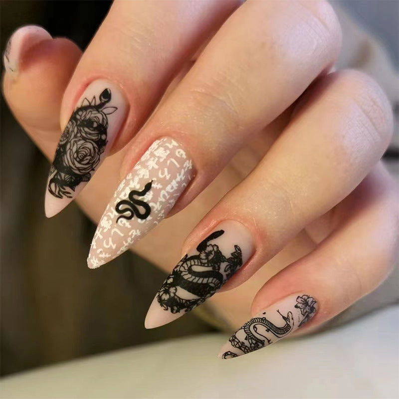 Artful nail extensions in elegant stiletto style with artistic floral and graphic designs Kalsten