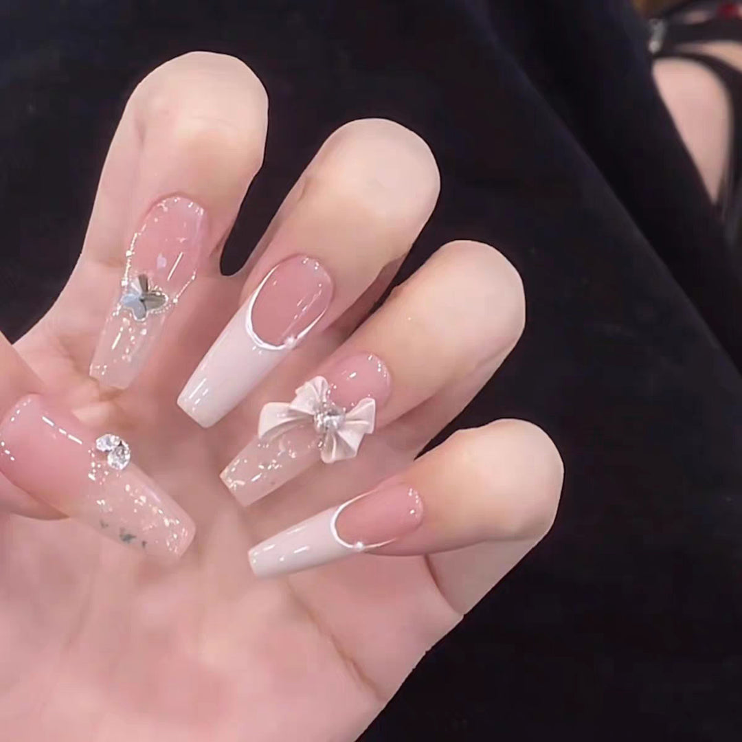 Artificial nails with glitter accents and playful motifs Kalsten