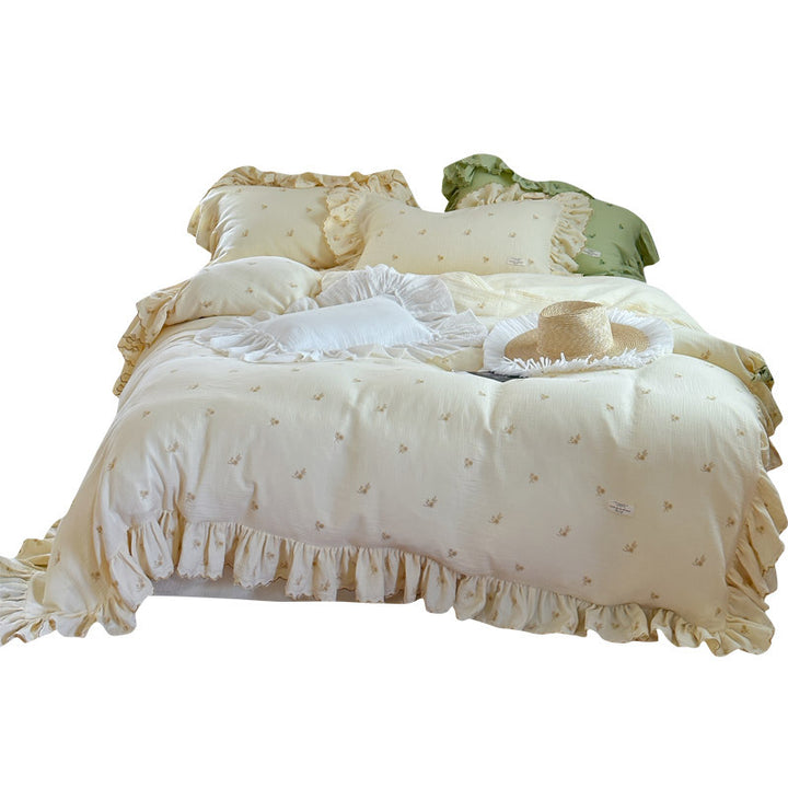 Vintage-inspired bedding set with ruffles and delicate floral embroidery