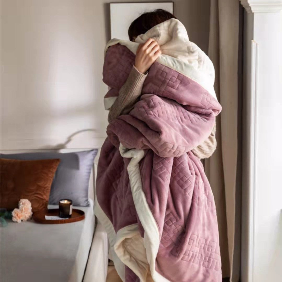 Reversible quilted comforter with structured box stitching and cotton trim