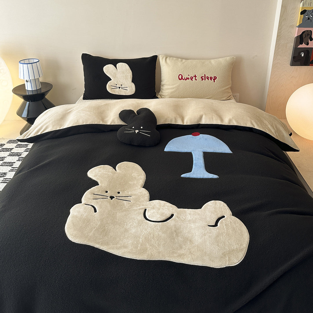 Cozy bedding set with embroidered cat appliqués and soft fleece surface