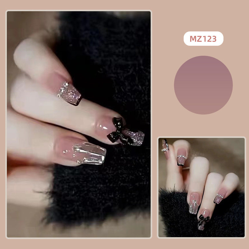 Elegant nail design with bow and rhinestone details Kalsten