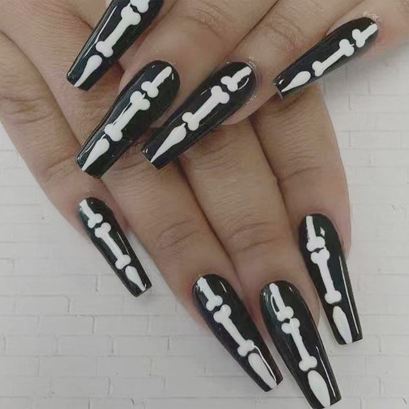 Artistic nail art with skull and bone motif Kalsten