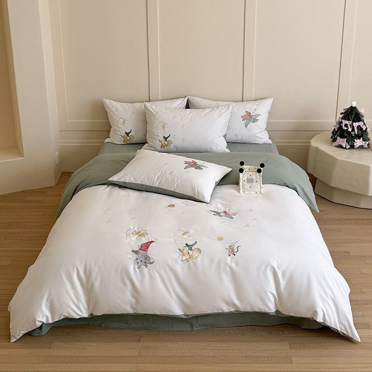 Children's bedding set with embroidered fairy tale forest motifs and reversible option