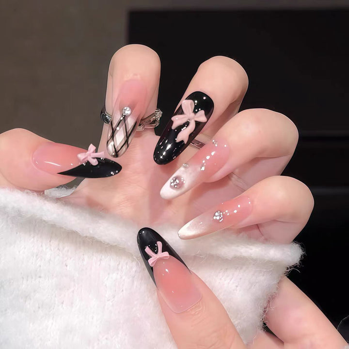 Artificial nails with playful bow design and glitter effects Kalsten