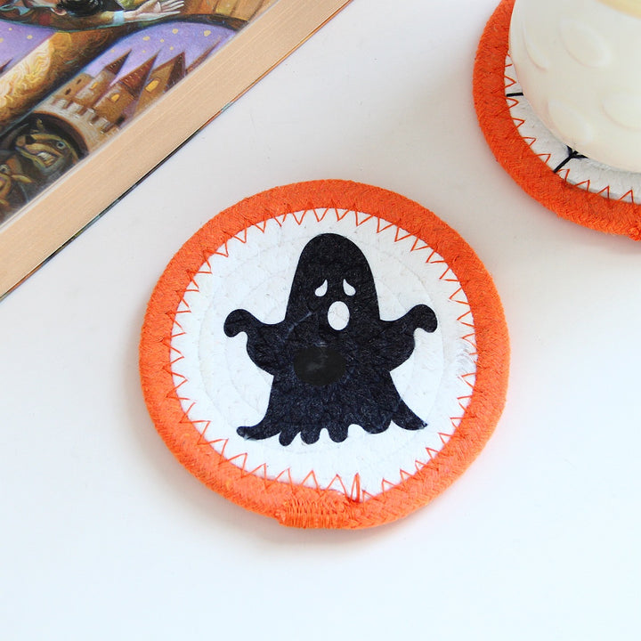 Round felt and cotton coasters with embroidered Halloween haunted house motif