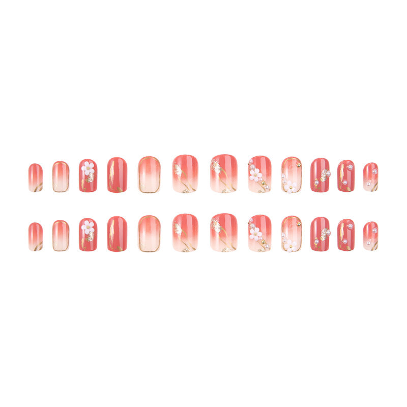 Acrylic nail set with elegant floral decorations and glamorous pearl accents Kalsten