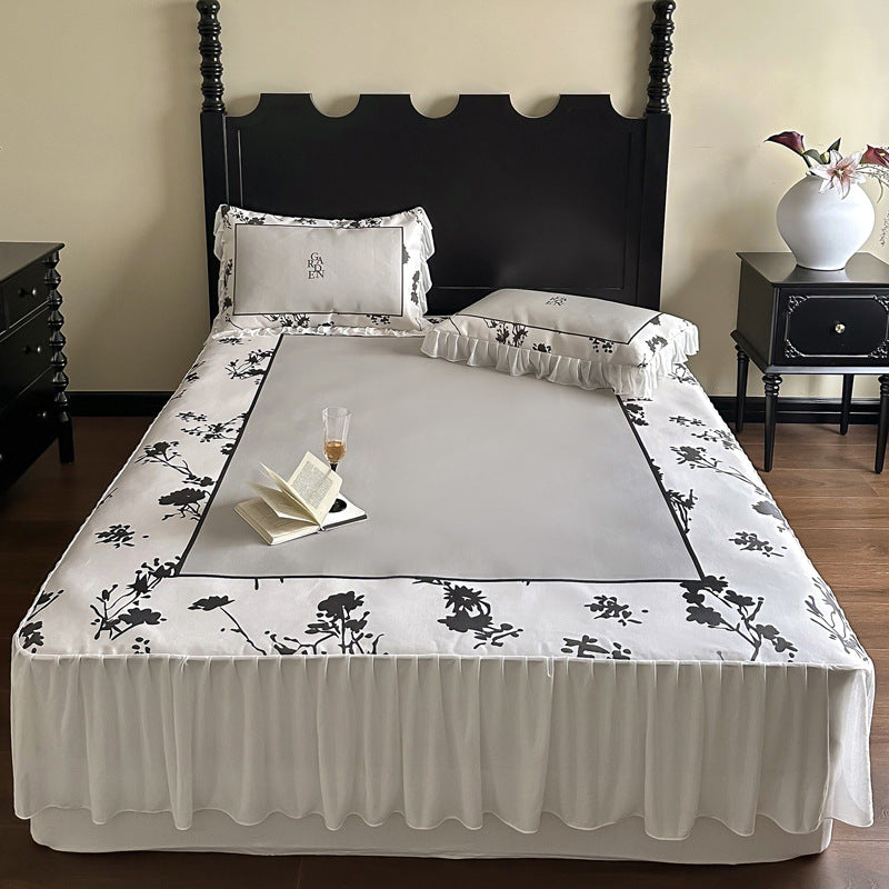 Bedding set with ruffled bed skirt, floral printed center piece and frill pillow