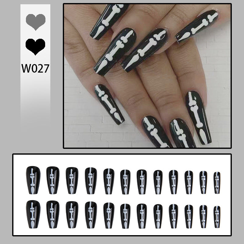 Artistic nail art with skull and bone motif Kalsten