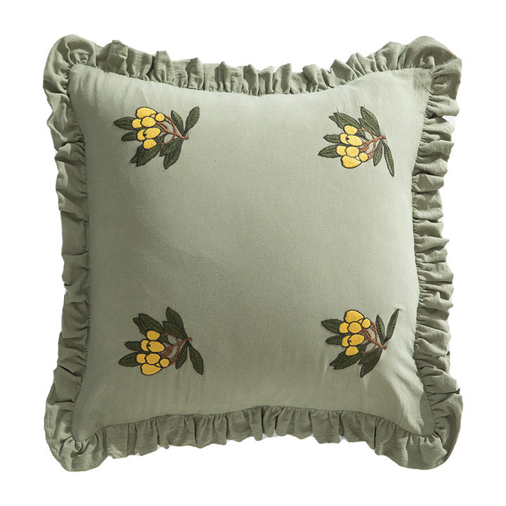 Square decorative pillow with ruffled edges and hand-stitched flower appliqués