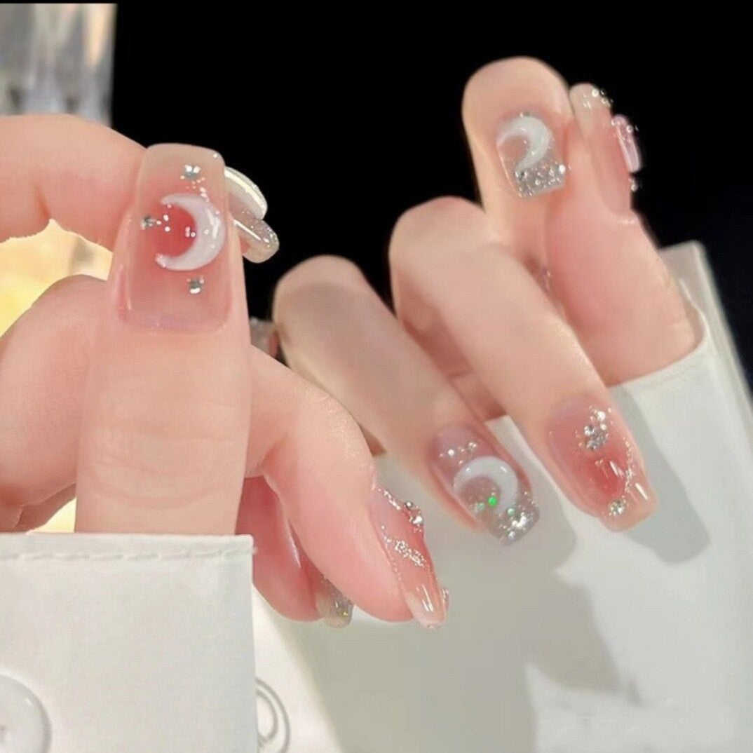 Glittering artificial nails with moon and star motifs Kalsten